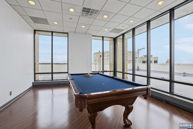 playroom featuring a drop ceiling, expansive windows, dark wood-type flooring, and billiards