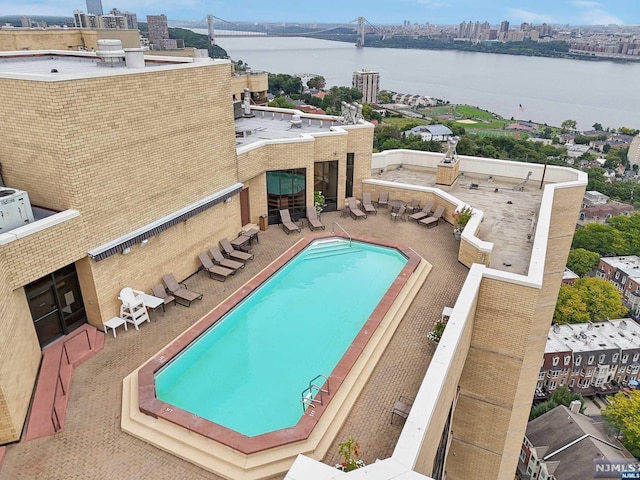 view of swimming pool featuring a water view