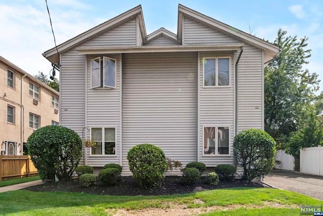 view of side of home with a lawn