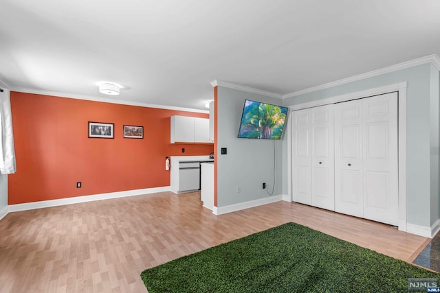 interior space featuring crown molding and light hardwood / wood-style flooring