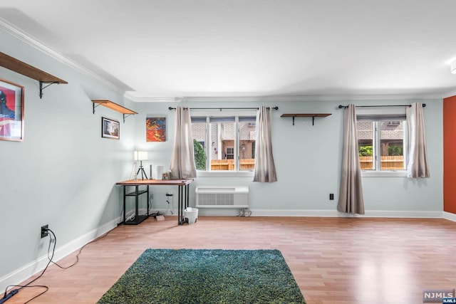 interior space with light hardwood / wood-style flooring, a wall mounted air conditioner, and ornamental molding