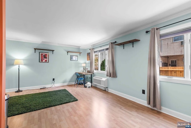 interior space featuring a wall unit AC, crown molding, and hardwood / wood-style flooring