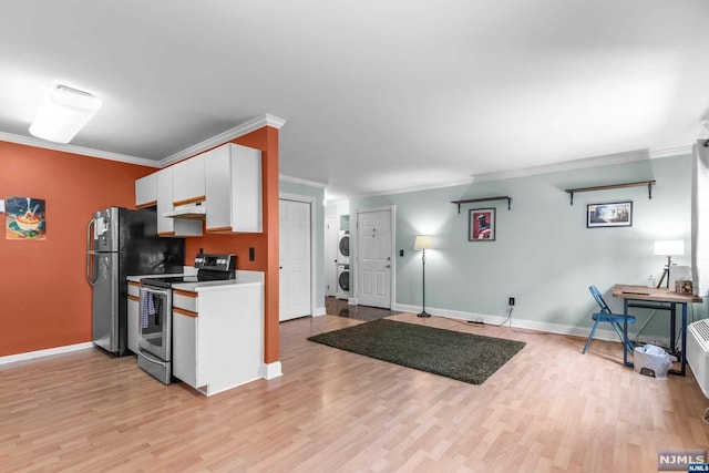 kitchen featuring stacked washer and dryer, light hardwood / wood-style flooring, ornamental molding, appliances with stainless steel finishes, and white cabinetry