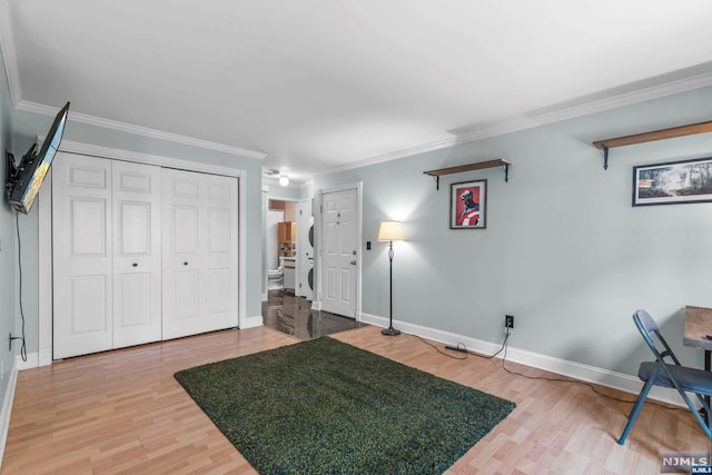 interior space with hardwood / wood-style flooring and crown molding