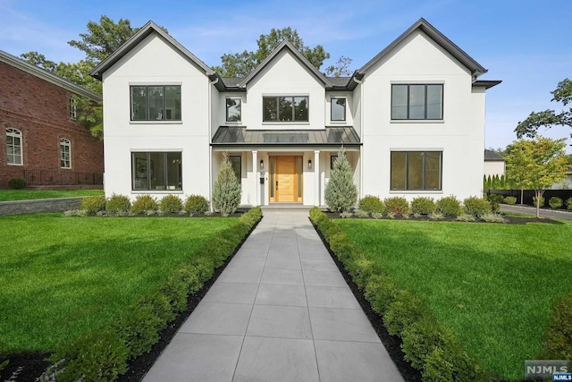 modern inspired farmhouse with a front lawn