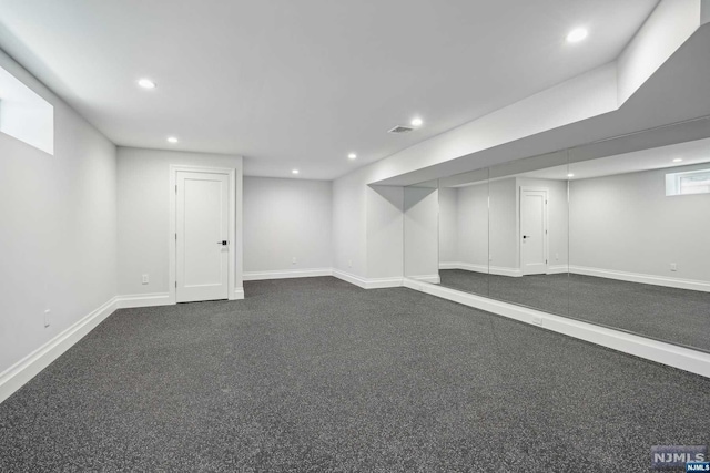 basement with dark carpet