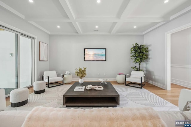 living room featuring beamed ceiling, light hardwood / wood-style floors, and coffered ceiling