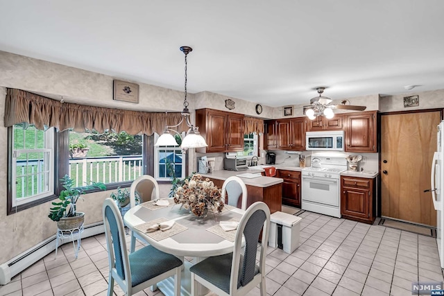 kitchen featuring ceiling fan, a baseboard heating unit, pendant lighting, white appliances, and light tile patterned floors