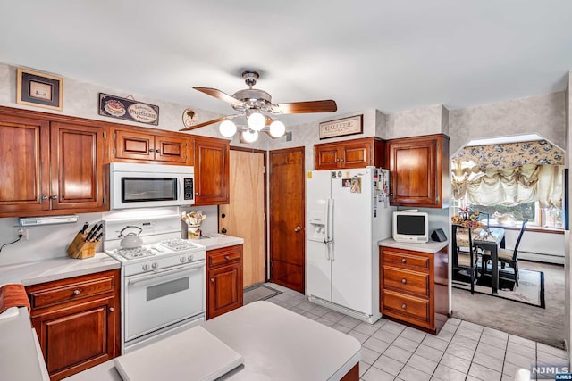 kitchen featuring ceiling fan, white appliances, and light carpet