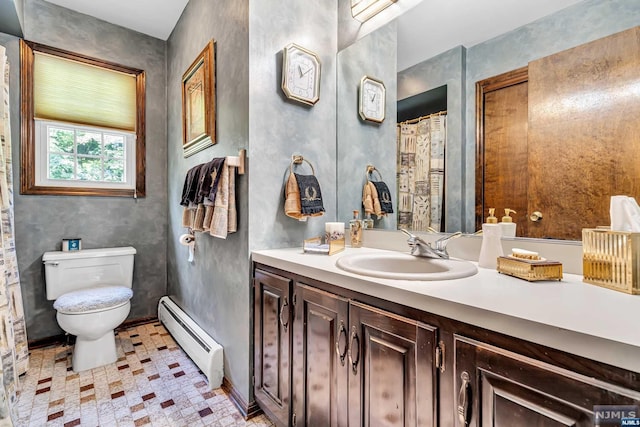 bathroom with baseboard heating, tile patterned floors, vanity, and toilet