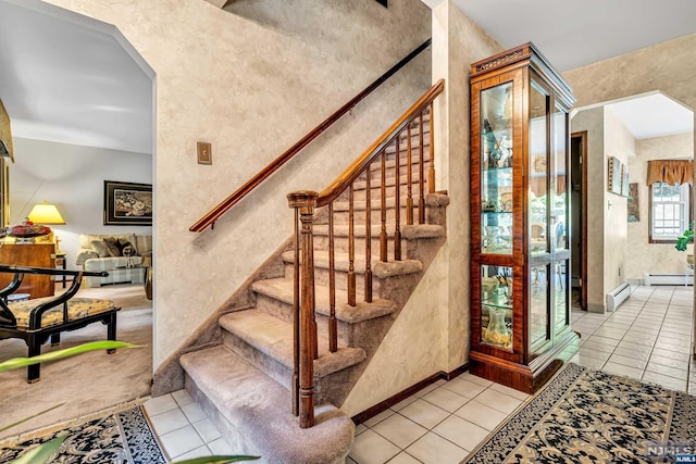 stairs with tile patterned flooring and a baseboard radiator