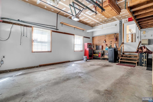 garage with a workshop area and a garage door opener