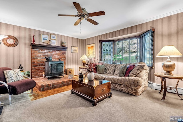 living room with a wood stove, crown molding, ceiling fan, and parquet flooring