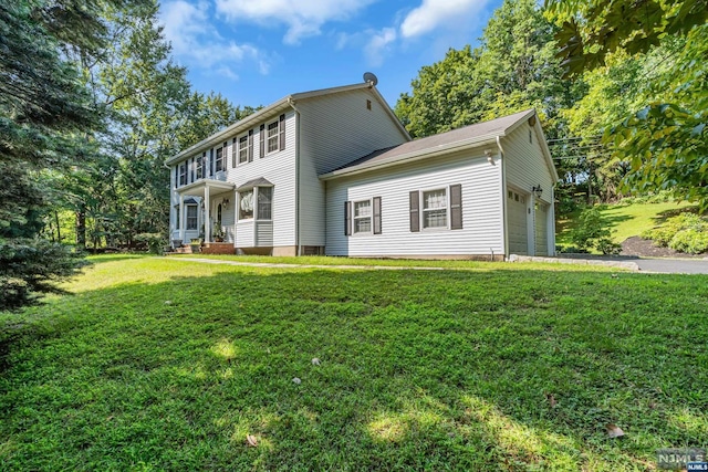 view of front of property with a front lawn and a garage