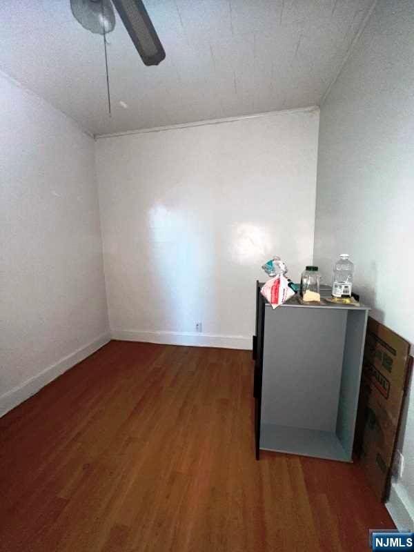 spare room featuring ceiling fan and dark hardwood / wood-style flooring