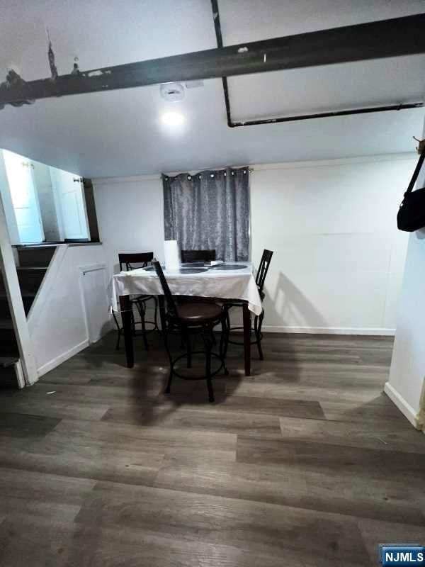 dining space featuring dark hardwood / wood-style floors