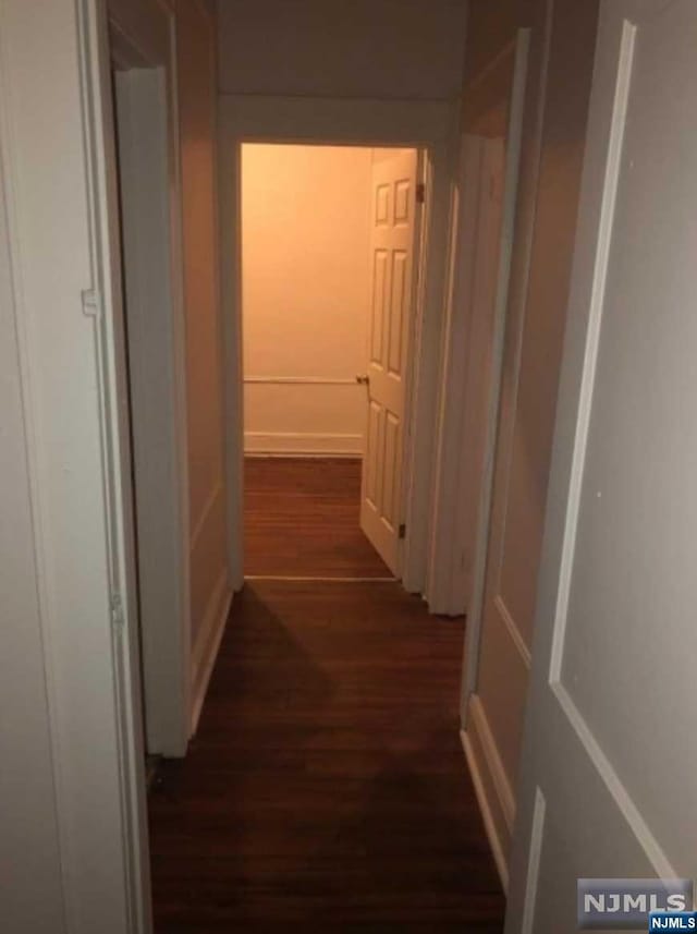 hallway featuring dark hardwood / wood-style floors