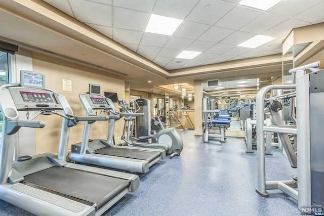 exercise room featuring a paneled ceiling