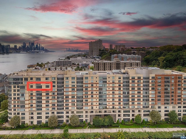 outdoor building at dusk featuring a water view