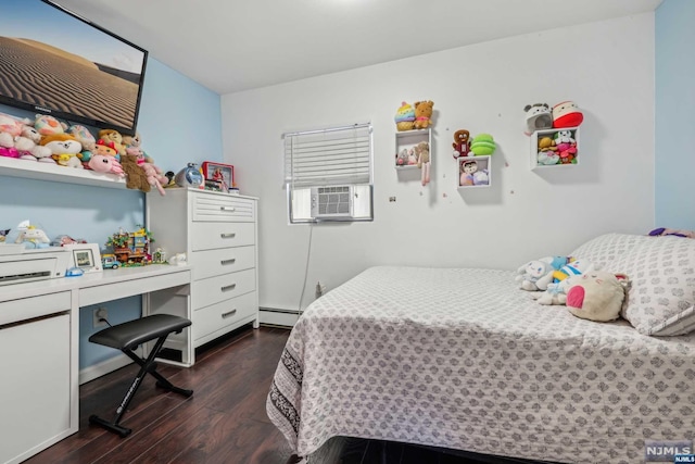 bedroom with a baseboard heating unit and dark wood-type flooring