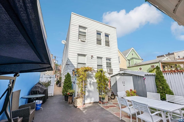 rear view of house with cooling unit and a patio