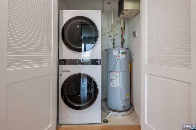 laundry area with stacked washing maching and dryer and water heater