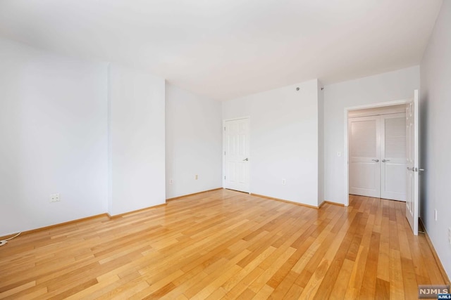 unfurnished room featuring hardwood / wood-style flooring