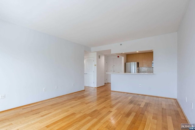 unfurnished living room featuring light wood-type flooring