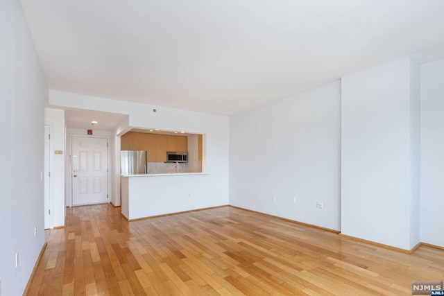 unfurnished living room featuring light hardwood / wood-style floors