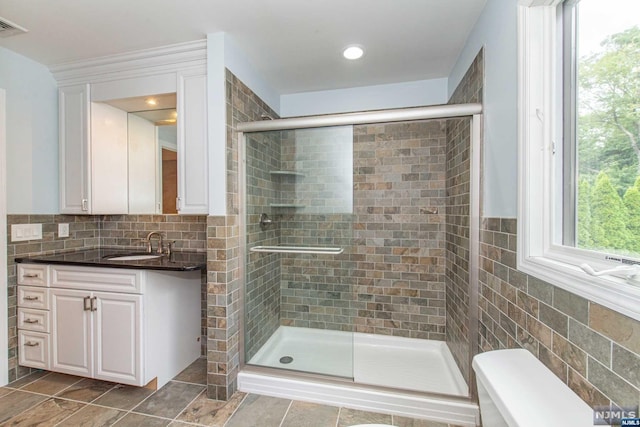 bathroom with vanity and walk in shower