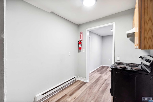 kitchen featuring light wood-type flooring, black range with electric cooktop, and a baseboard heating unit