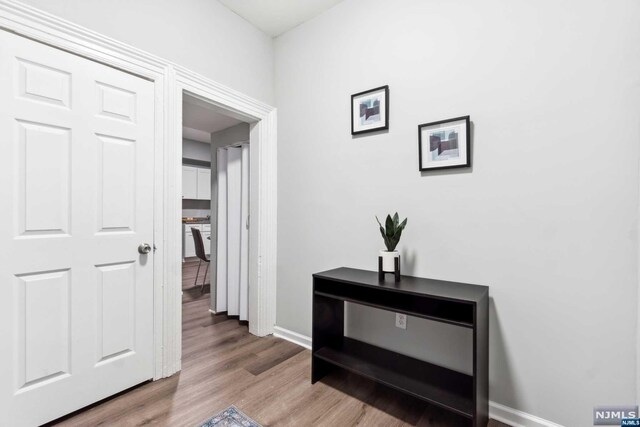 corridor with light hardwood / wood-style floors