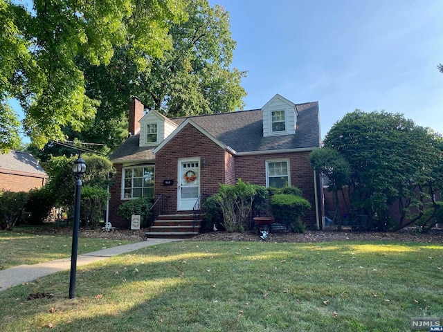 cape cod home with a front lawn