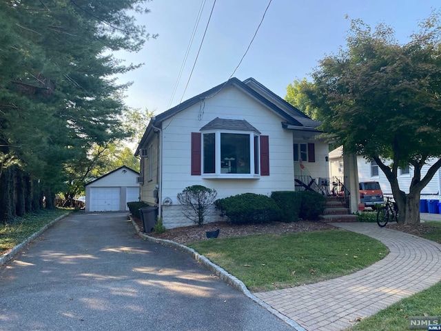 view of front of property with a garage and an outdoor structure