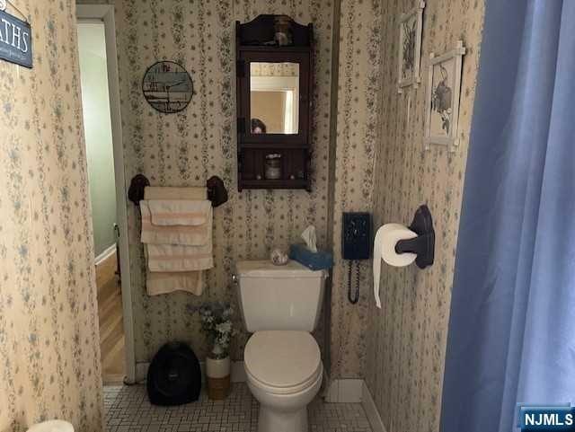 bathroom with tile patterned flooring and toilet