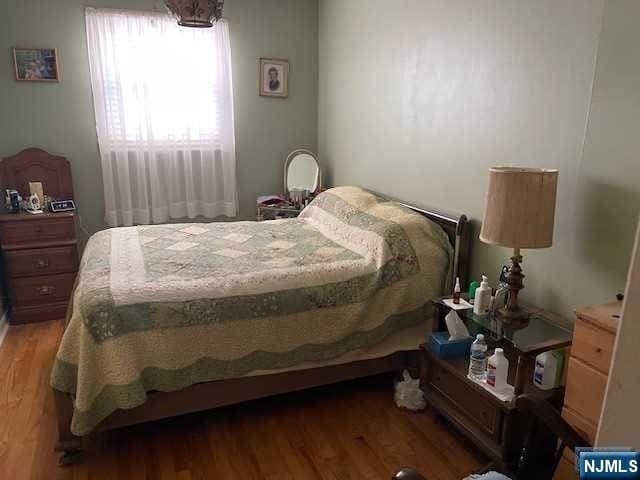 bedroom with wood-type flooring