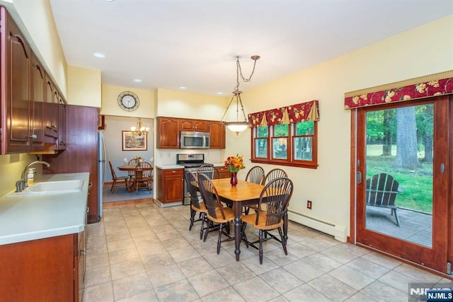 dining area with baseboards, a chandelier, baseboard heating, and light tile patterned flooring