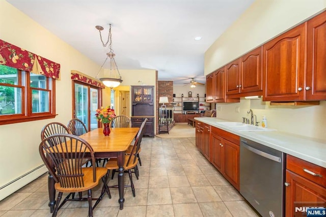 kitchen featuring pendant lighting, light countertops, stainless steel dishwasher, a baseboard heating unit, and a sink