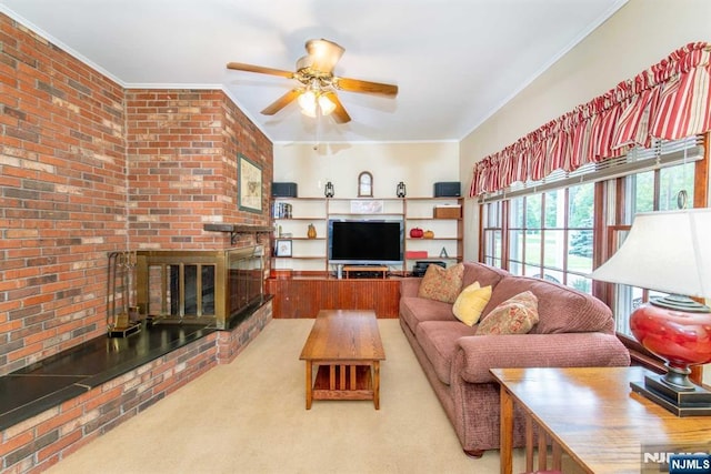 carpeted living area featuring ceiling fan, brick wall, ornamental molding, and a fireplace