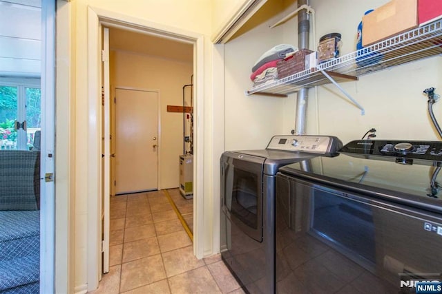 laundry area featuring laundry area, washing machine and dryer, and light tile patterned flooring