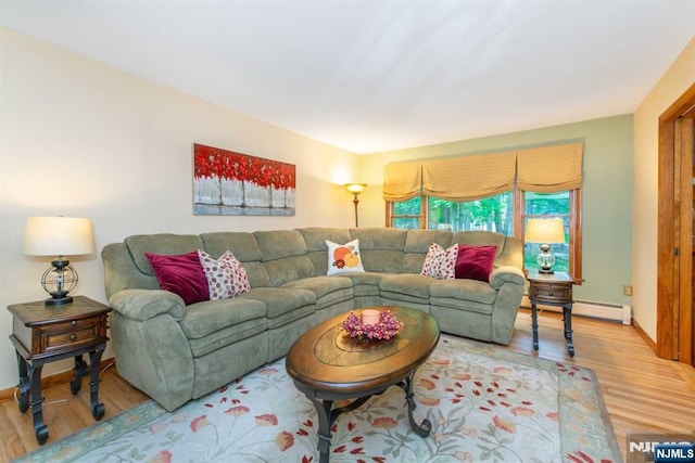 living area featuring baseboards and wood finished floors