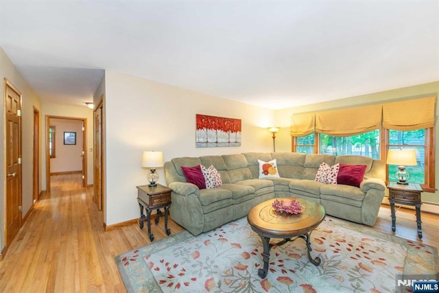 living room with baseboards and light wood-style floors