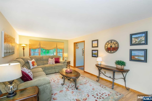 living room featuring baseboards and wood finished floors