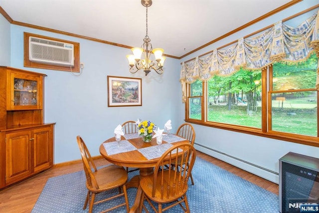 dining room with a baseboard radiator, an inviting chandelier, ornamental molding, light wood-type flooring, and a wall mounted air conditioner