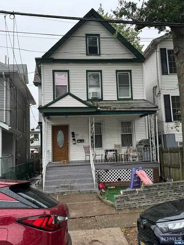 view of front of house with cooling unit and a porch