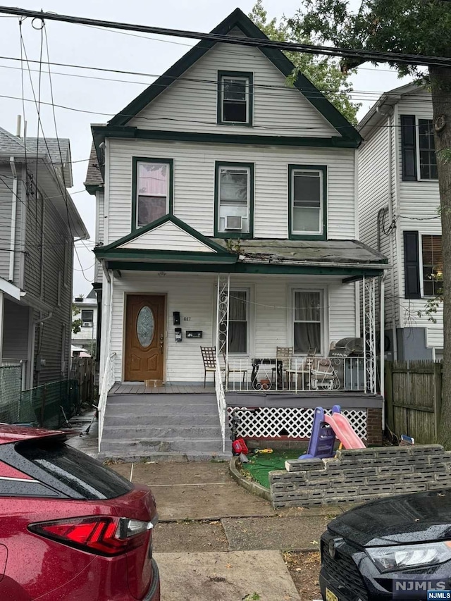 view of front of property with cooling unit and covered porch