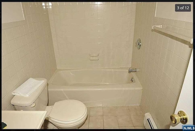 bathroom featuring tile patterned flooring, toilet, tile walls, and a baseboard heating unit