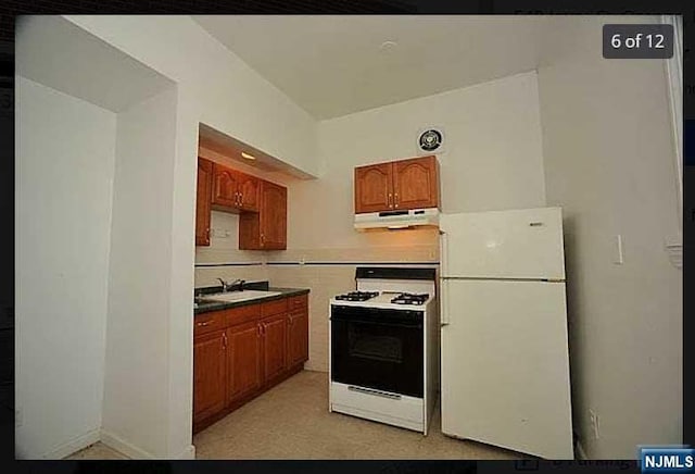 kitchen with white appliances and sink