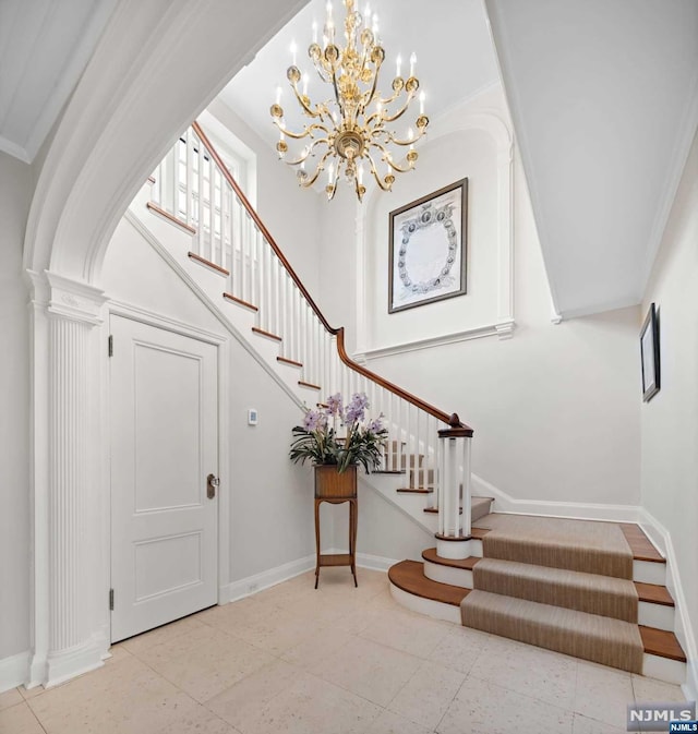 interior space with crown molding and an inviting chandelier