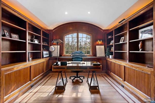 office featuring built in shelves and wood-type flooring